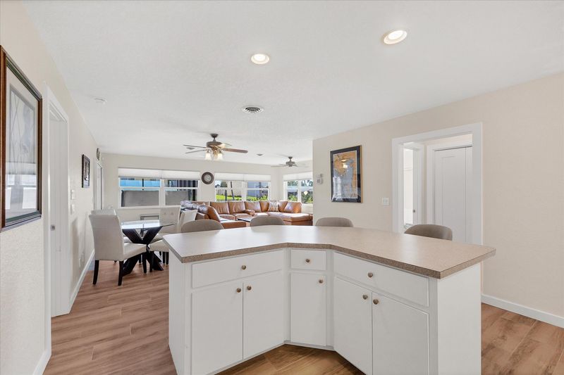 Fully-equipped kitchen overlooking the dining room and living room. Dining table seats 4 with an additional 4 at the kitchen island