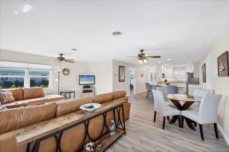 Bright, open living space. Livingroom features large sectional sofa and 50-inch Smart TV