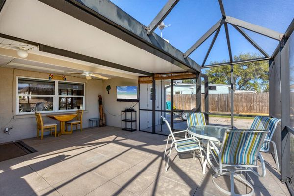 Screened-in patio overlooking the canal with private hot tub that seats 6 and outdoor dining area