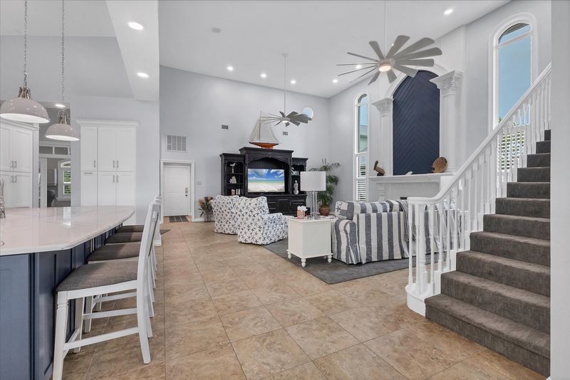 Large, open living space with ample seating, fireplace and 70-inch Smart TV