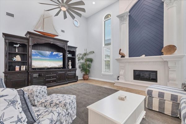 Large, open living space with ample seating, fireplace and 70-inch Smart TV