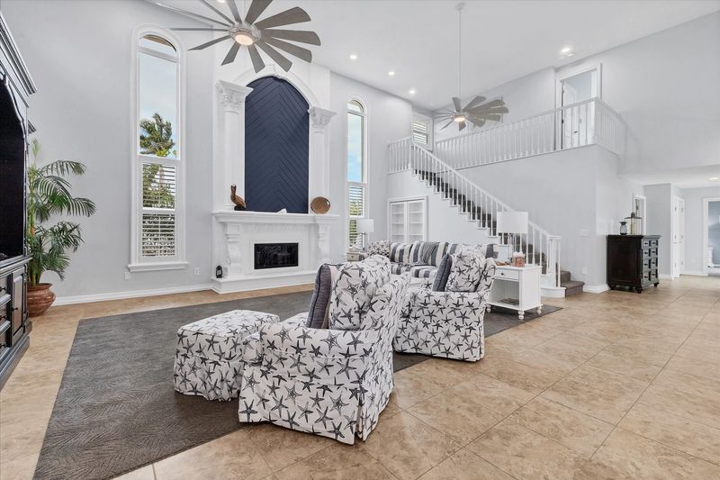 Large, open living space with ample seating, fireplace and 70-inch Smart TV