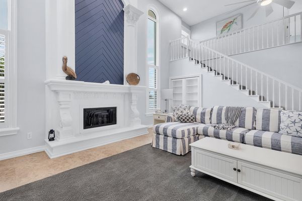 Large, open living space with ample seating, fireplace and 70-inch Smart TV