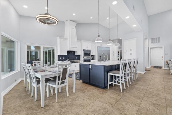 Dining area with water view. Dining table seats six, with additional seating for four at the kitchen island