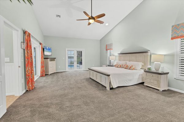 Primary bedroom features a king bed, lanai access, beautiful en suite, and 48-inch Smart TV