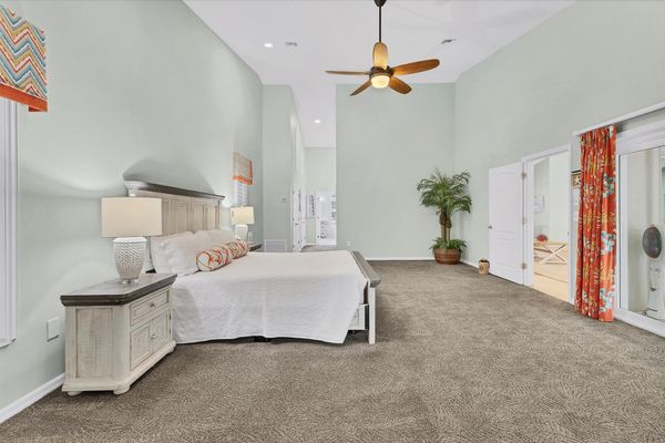 Primary bedroom features a king bed, lanai access, beautiful en suite, and 48-inch Smart TV