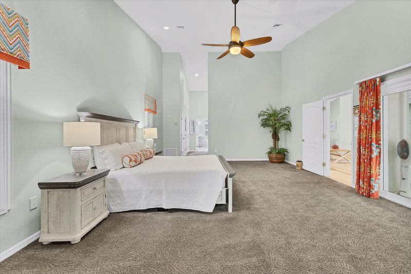 Primary bedroom features a king bed, lanai access, beautiful en suite, and 48-inch Smart TV