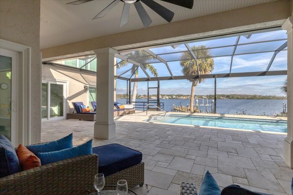 Large lanai overlooking the sparkling pool and Lemon Bay