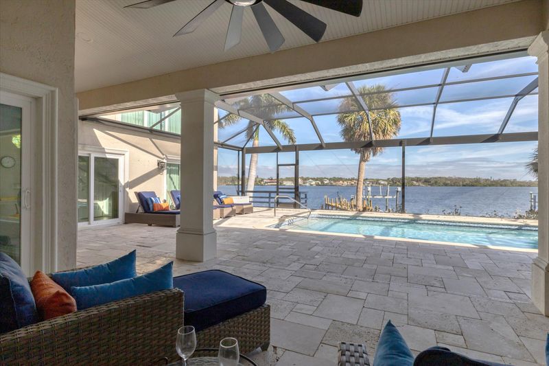 Large lanai overlooking the sparkling pool and Lemon Bay
