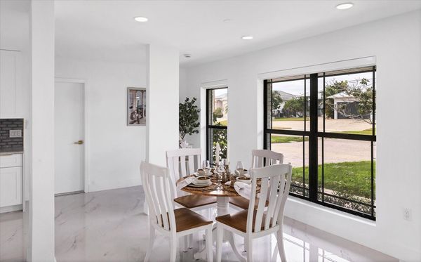 Dining area. Dining table seats 4 with additional seating at kitchen island, bar top table, and kitchen nook area