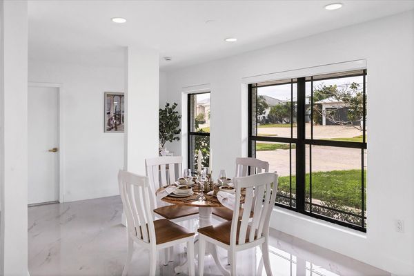 Dining area. Dining table seats 4 with additional seating at kitchen island, bar top table, and kitchen nook area