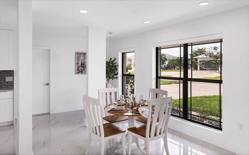 Dining area. Dining table seats 4 with additional seating at kitchen island, bar top table, and kitchen nook area