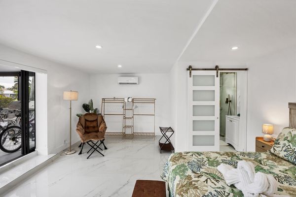 King suite with one king bed, attached bathroom, lanai access, and 32-inch Smart TV