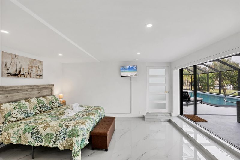 King suite with one king bed, attached bathroom, lanai access, and 32-inch Smart TV