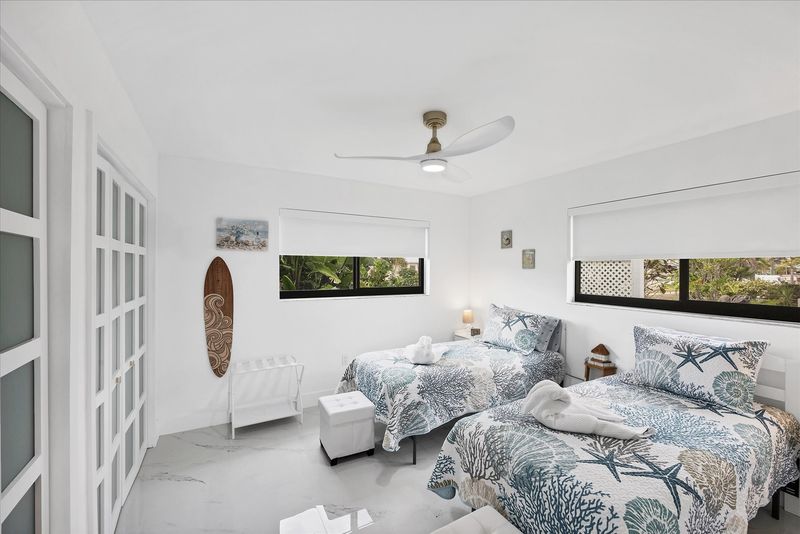Twins bedroom featuring two twin beds and 24-inch Smart TV