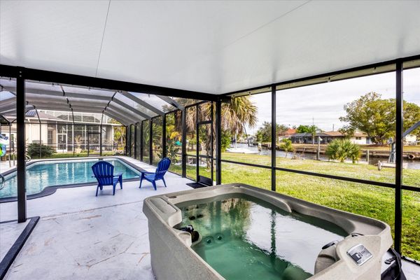 Extra large lanai overlooking the canal. Includes sparkling pool, relaxing hot tub, al fresco dining and more. Pool size: 14' x 28' x 6'