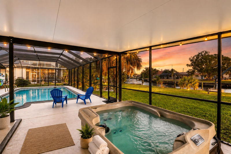 Extra large lanai overlooking the canal. Includes sparkling pool, relaxing hot tub, al fresco dining and more. Pool size: 14' x 28' x 6'