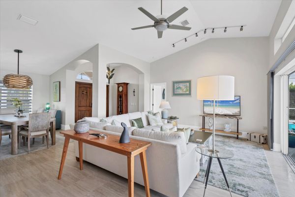 Family room overlooking sparkling pool and canal beyond. Features comfy seating and a 56-inch Smart TV