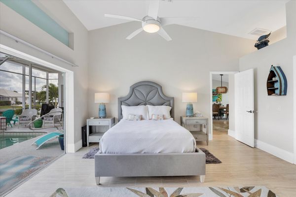 Primary bedroom with gorgeous water view, queen bed, attached bathroom and lanai access
