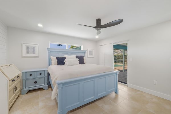 Bedroom 1 - King bed, attached bathroom, lanai access, and 50-inch Smart TV