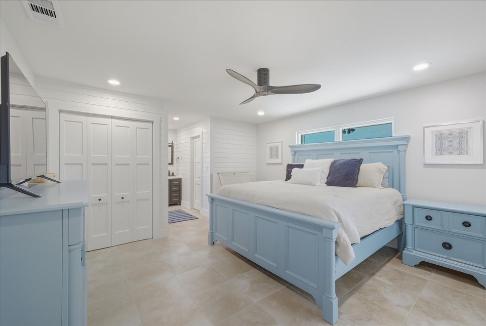 Bedroom 1 - King bed, attached bathroom, lanai access, and 50-inch Smart TV