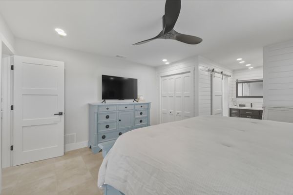 Bedroom 1 - King bed, attached bathroom, lanai access, and 50-inch Smart TV