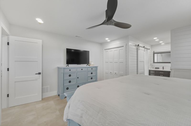 Bedroom 1 - King bed, attached bathroom, lanai access, and 50-inch Smart TV