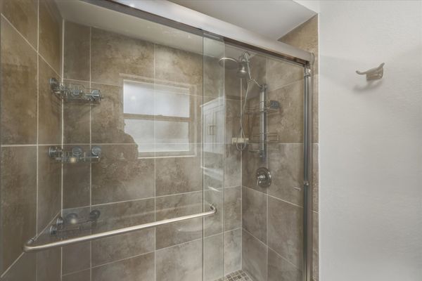 Bedroom 1's attached bathroom with walk-in shower and lots of closet space