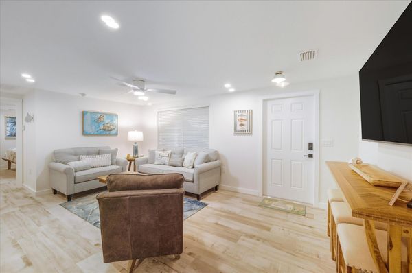 Living room featuring lots of comfy seating and 65-inch Smart TV