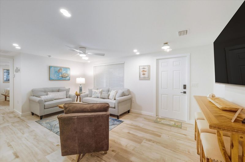 Living room featuring lots of comfy seating and 65-inch Smart TV