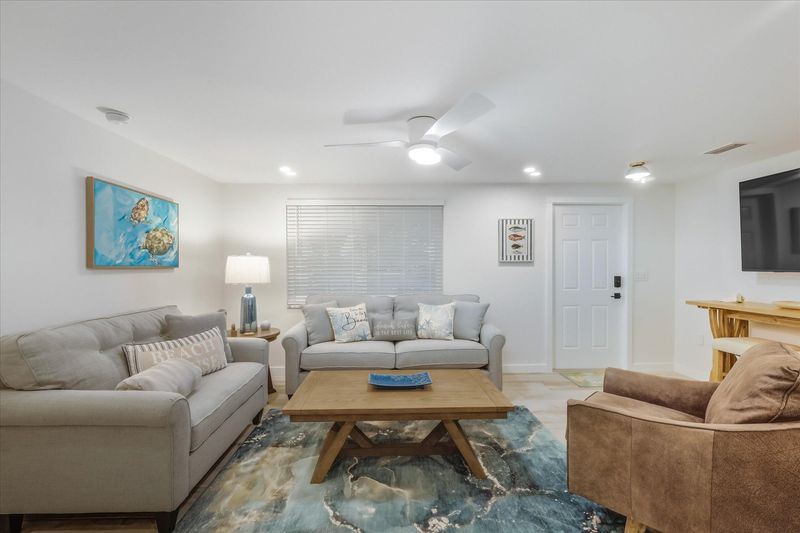 Living room featuring lots of comfy seating and 65-inch Smart TV