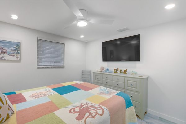 Bedroom 2 with queen bed and 55-inch Smart TV