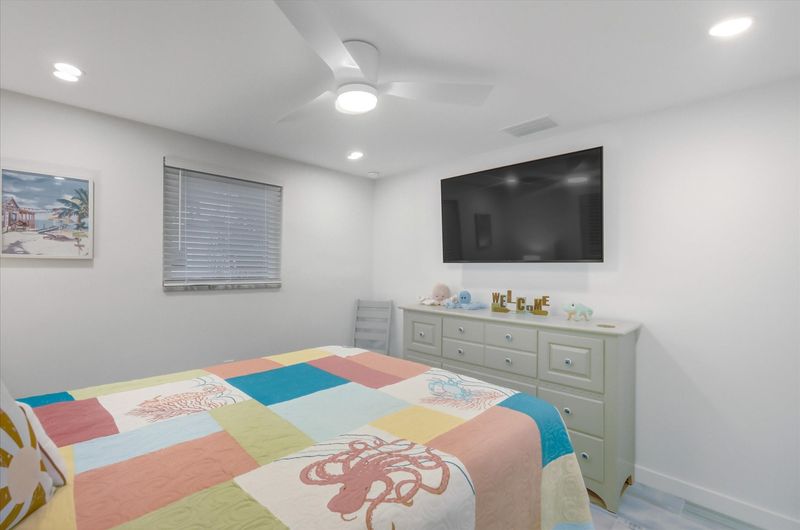 Bedroom 2 with queen bed and 55-inch Smart TV