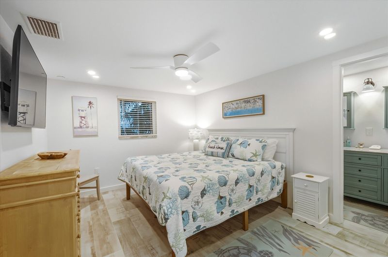 Bedroom 1 with king bed, attached bathroom and 55-inch Smart TV
