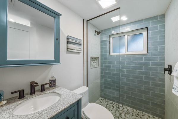 Bedroom 1's attached bathroom with walk-in shower and double vanities