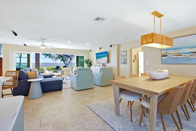 Beautiful open living space overlooking the sparkling pool with an amazing view of the Peace River