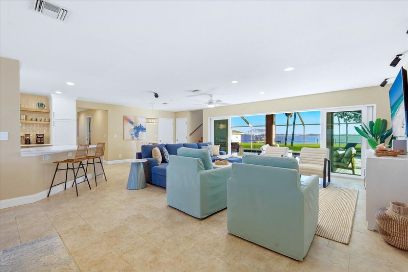 Beautiful open living space overlooking the sparkling pool with an amazing view of the Peace River