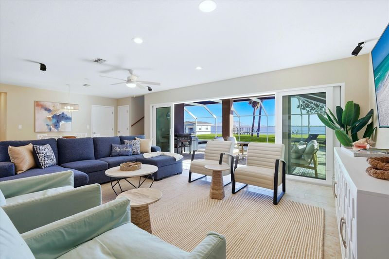 Living room features lots of comfy seating and 70-inch Smart TV
