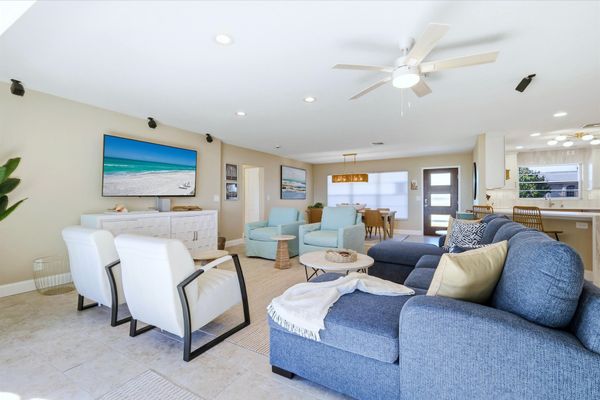 Living room features lots of comfy seating and 70-inch Smart TV