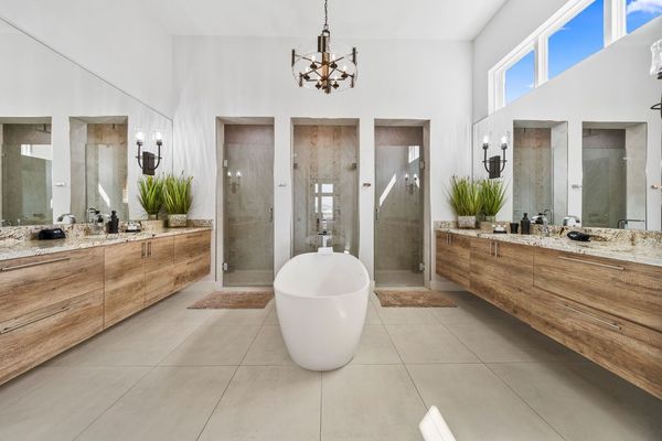 The ensuite bathroom has a beautiful garden tub and his and her showers