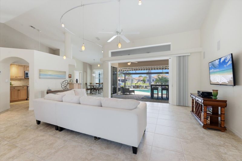 Large living room overlooking the lanai and sparkling pool