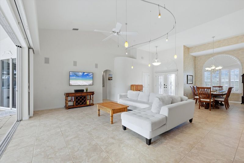 Large living room overlooking the lanai and sparkling pool
