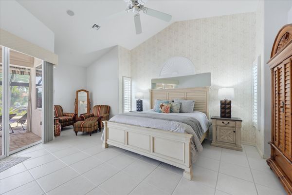 Primary bedroom with king bed, attached bathroom, lanai access, and 50-inch Smart TV