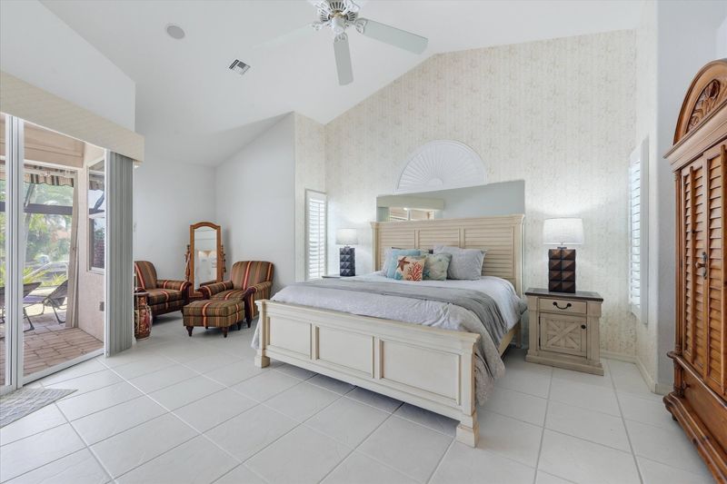 Primary bedroom with king bed, attached bathroom, lanai access, and 50-inch Smart TV
