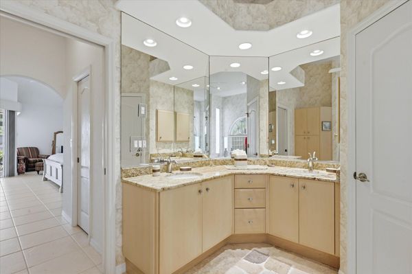 Primary bedroom's attached bathroom with walk-in shower, garden tub, and double vanities