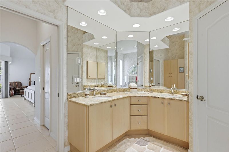 Primary bedroom's attached bathroom with walk-in shower, garden tub, and double vanities