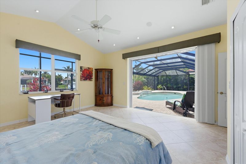 Bedroom 2 with queen Murphy bed, lanai access, and desk & chair
