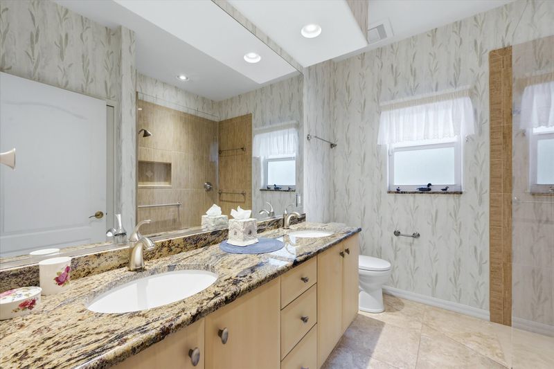 Guest bathroom with walk-in shower and double vanities
