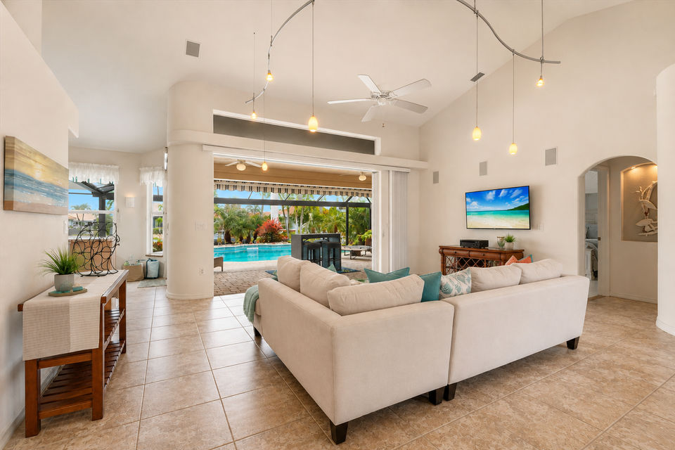 Large living room overlooking the lanai and sparkling pool