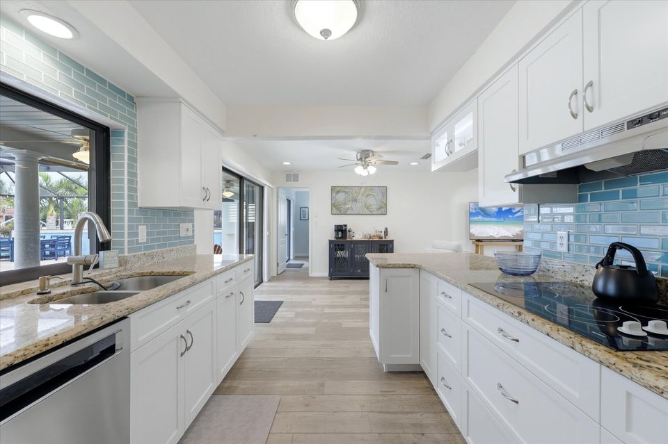 Bright, fully-equipped kitchen overlooking the pool and canal